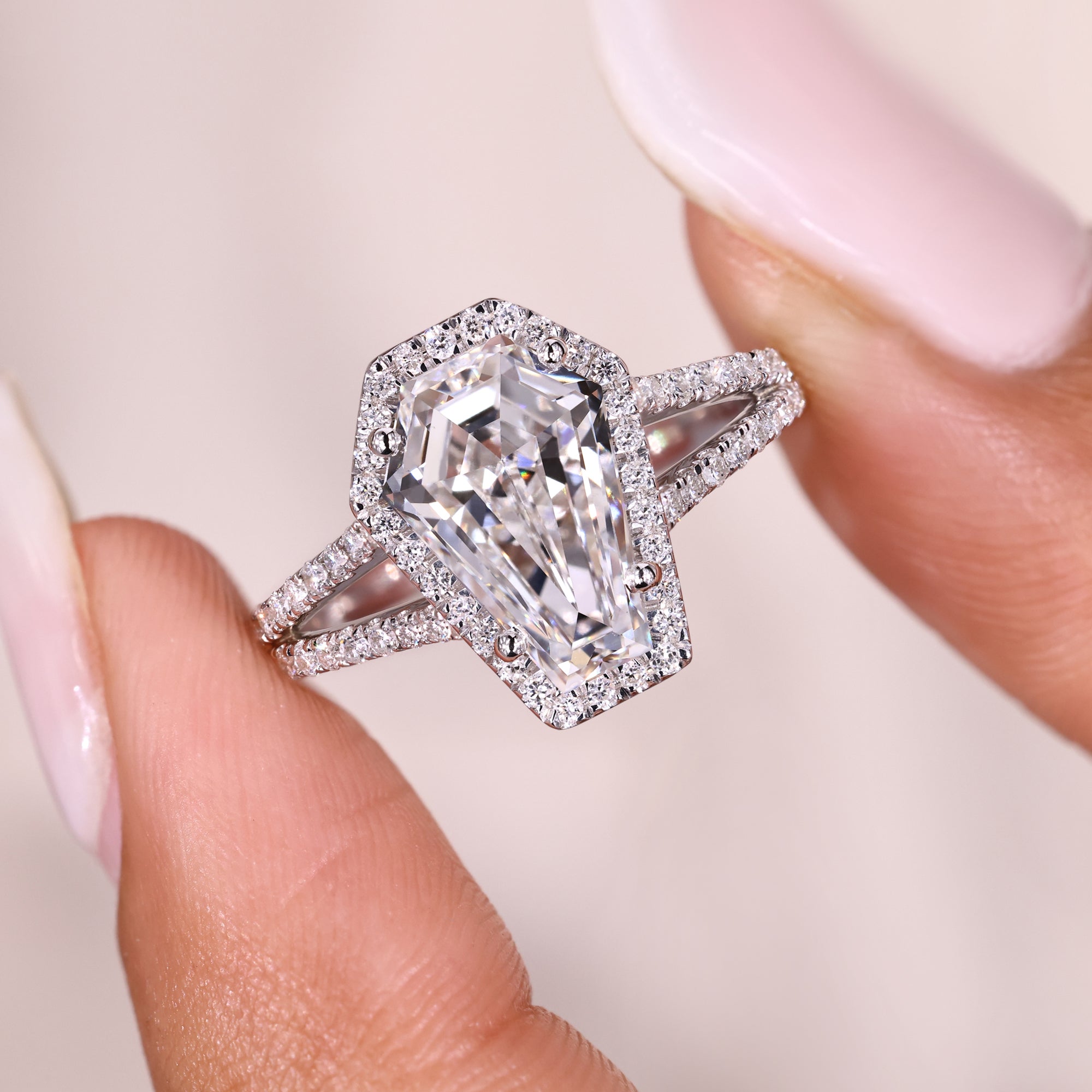 Coffin cut diamond ring with halo and split shank.
