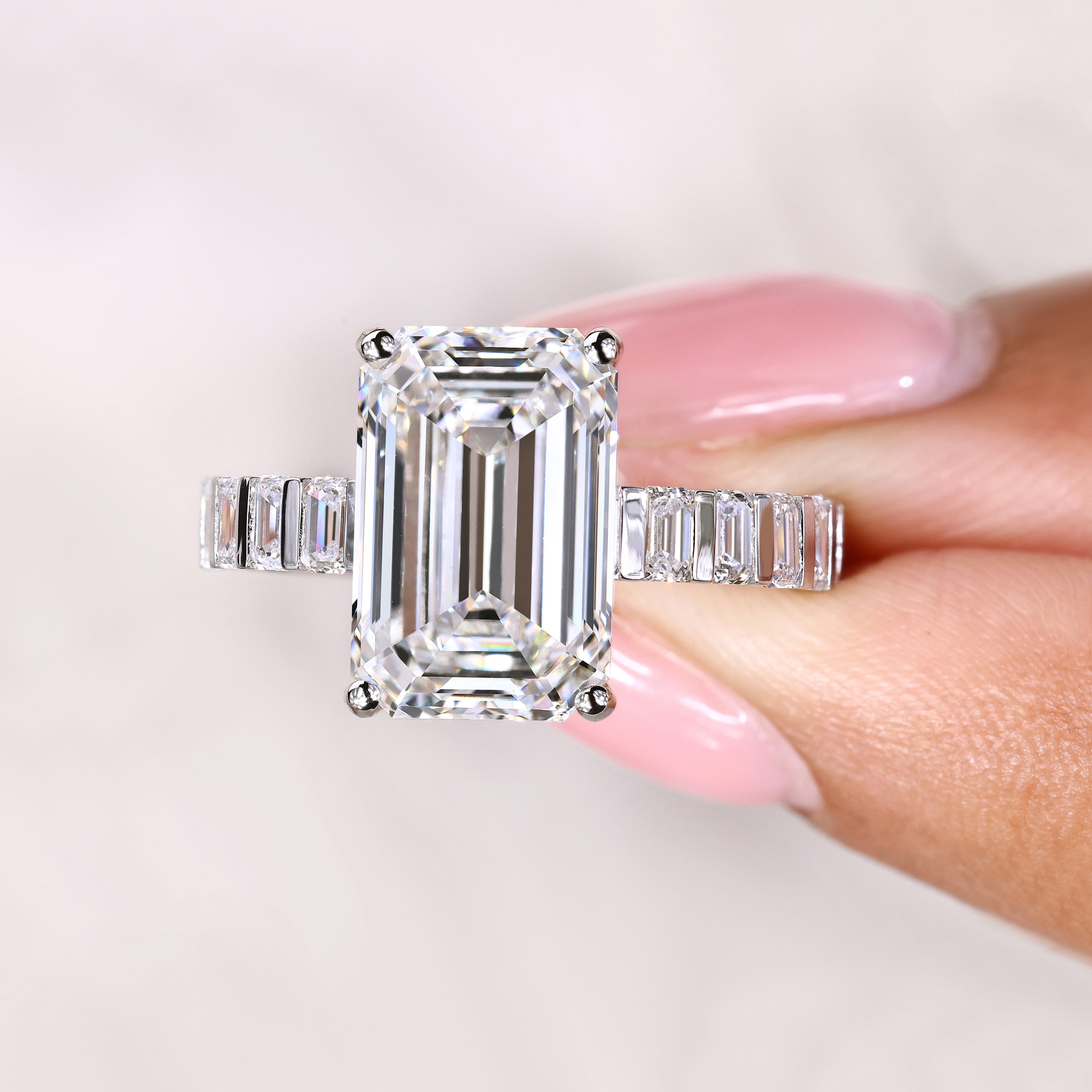 Lab grown emerald ring with bar set side diamonds
