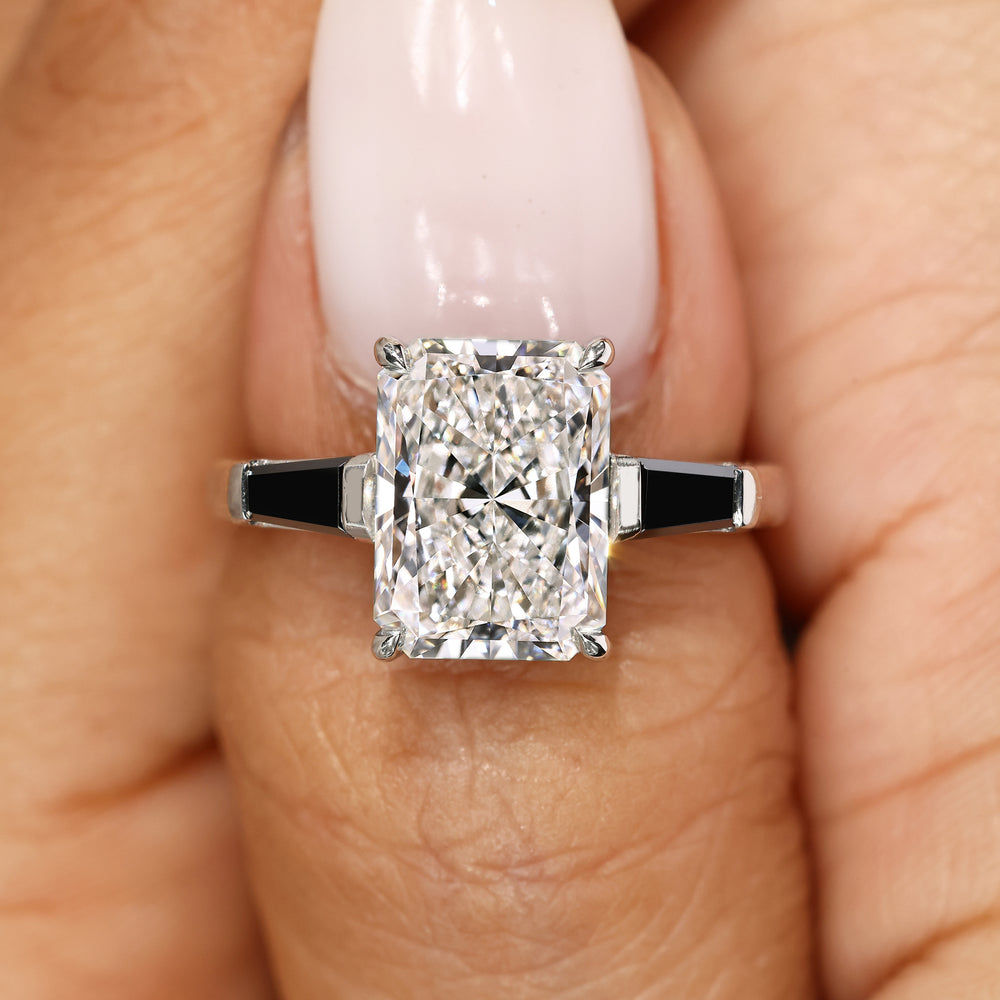 Radiant diamond ring with tapered baguette moissanite.
