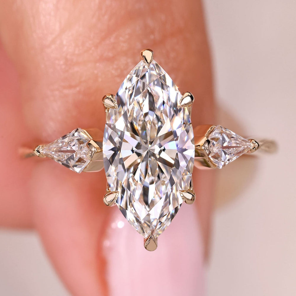 Elegant marquise cut diamond ring with tapered band.