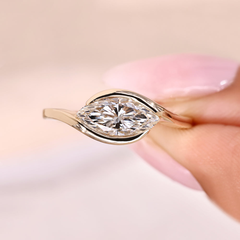 Marquise diamond ring with bypass design.
