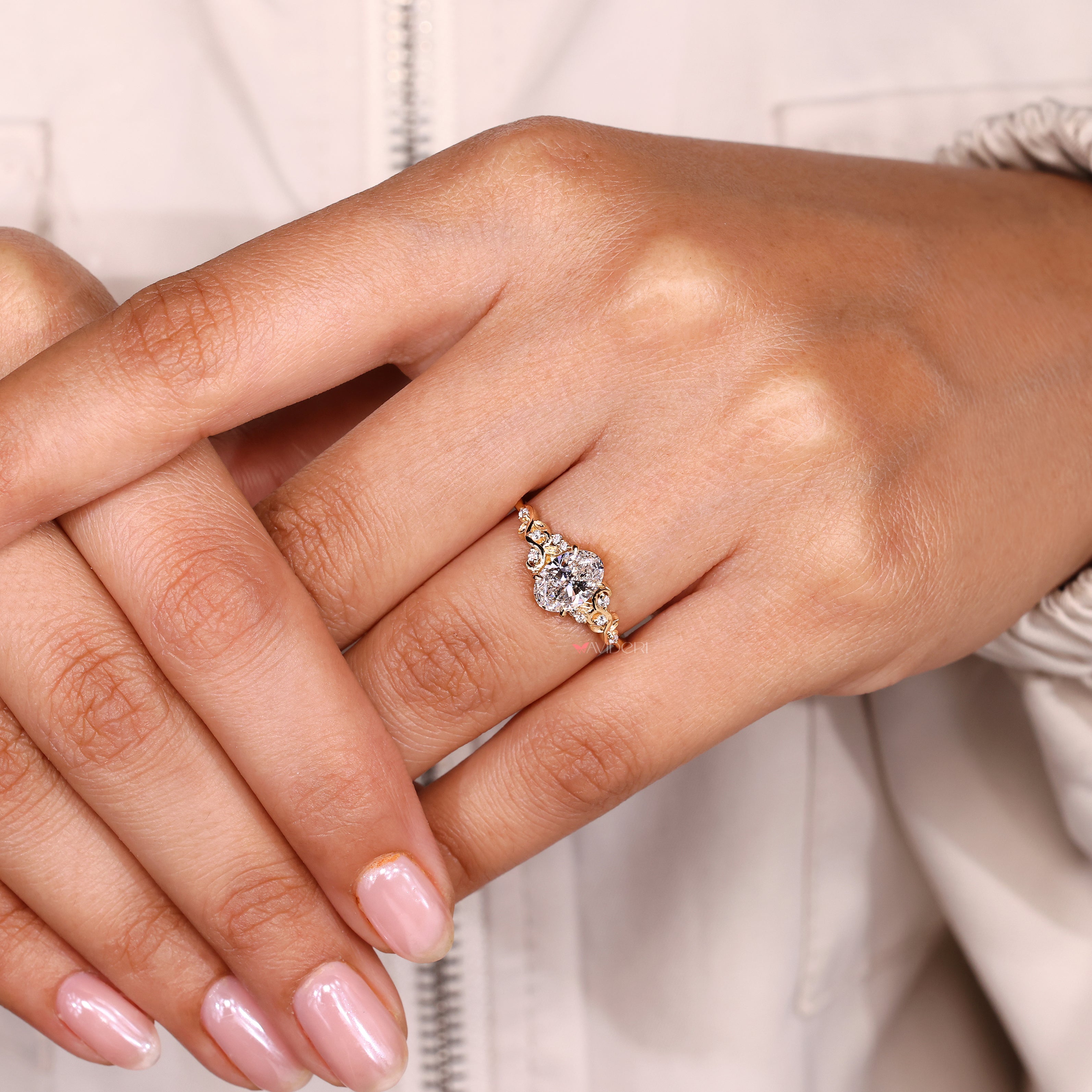 Oval ring with claw prong and side stones.
