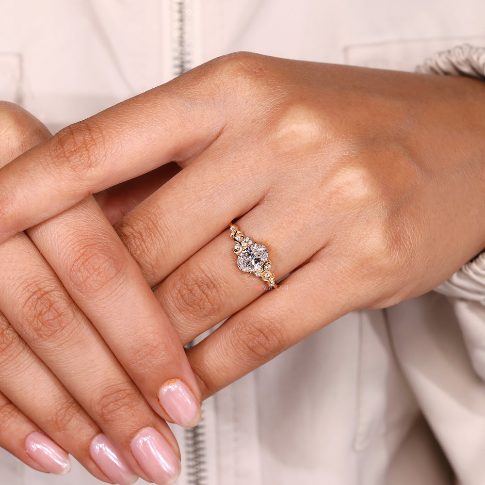 Oval ring with claw prong and side stones.
