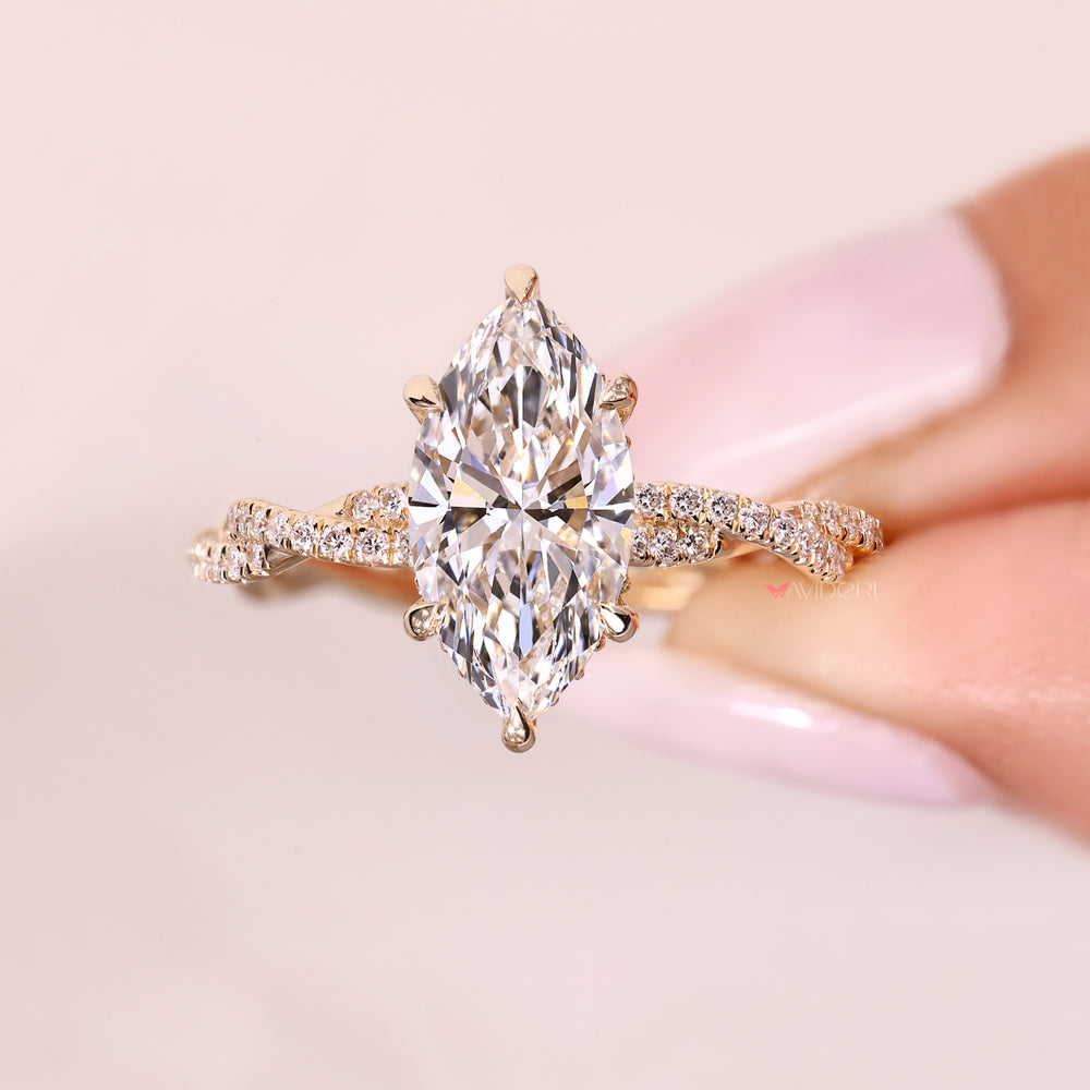 Elegant marquise diamond ring with twisted pave band.

