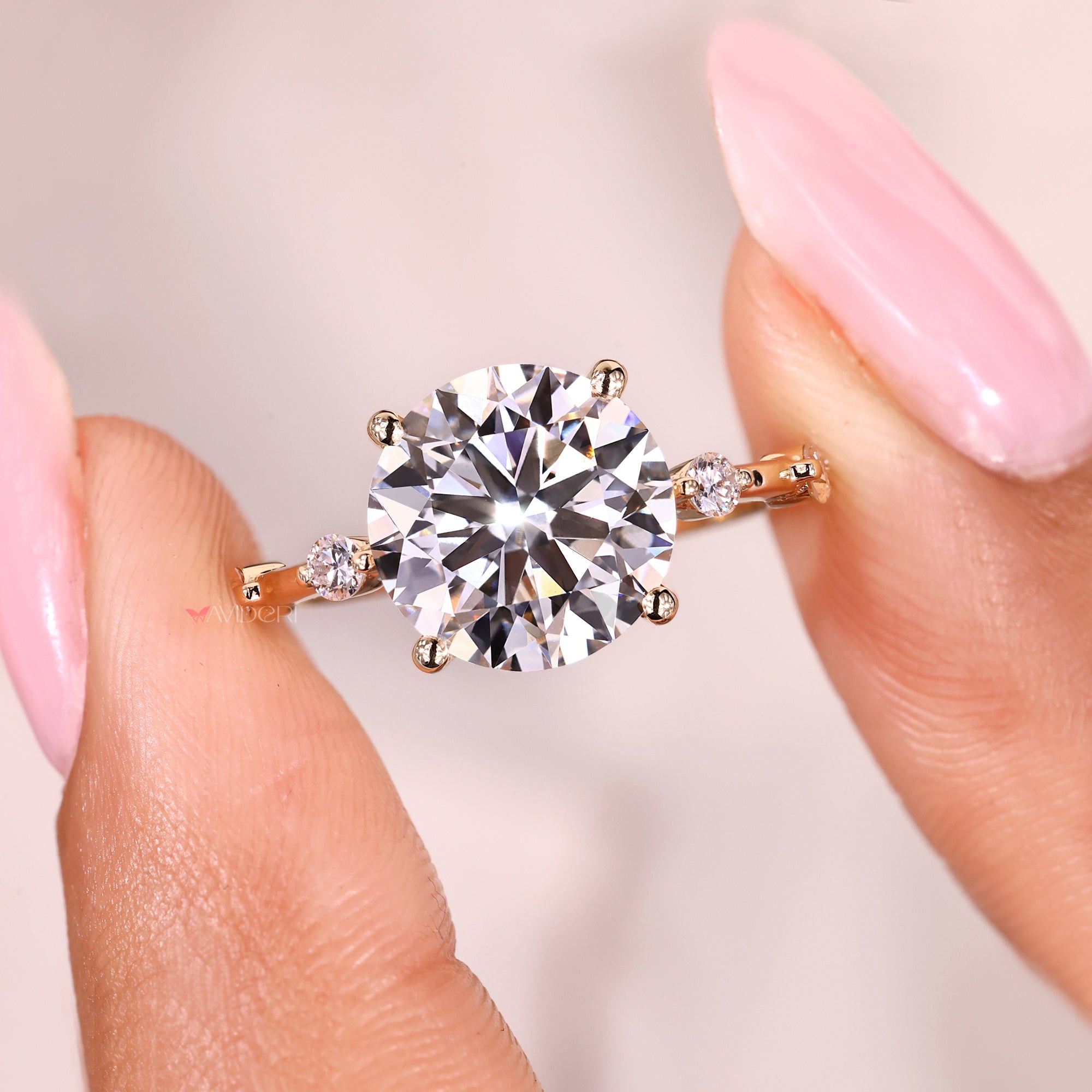 Round cut diamond ring with elegant side stones.
