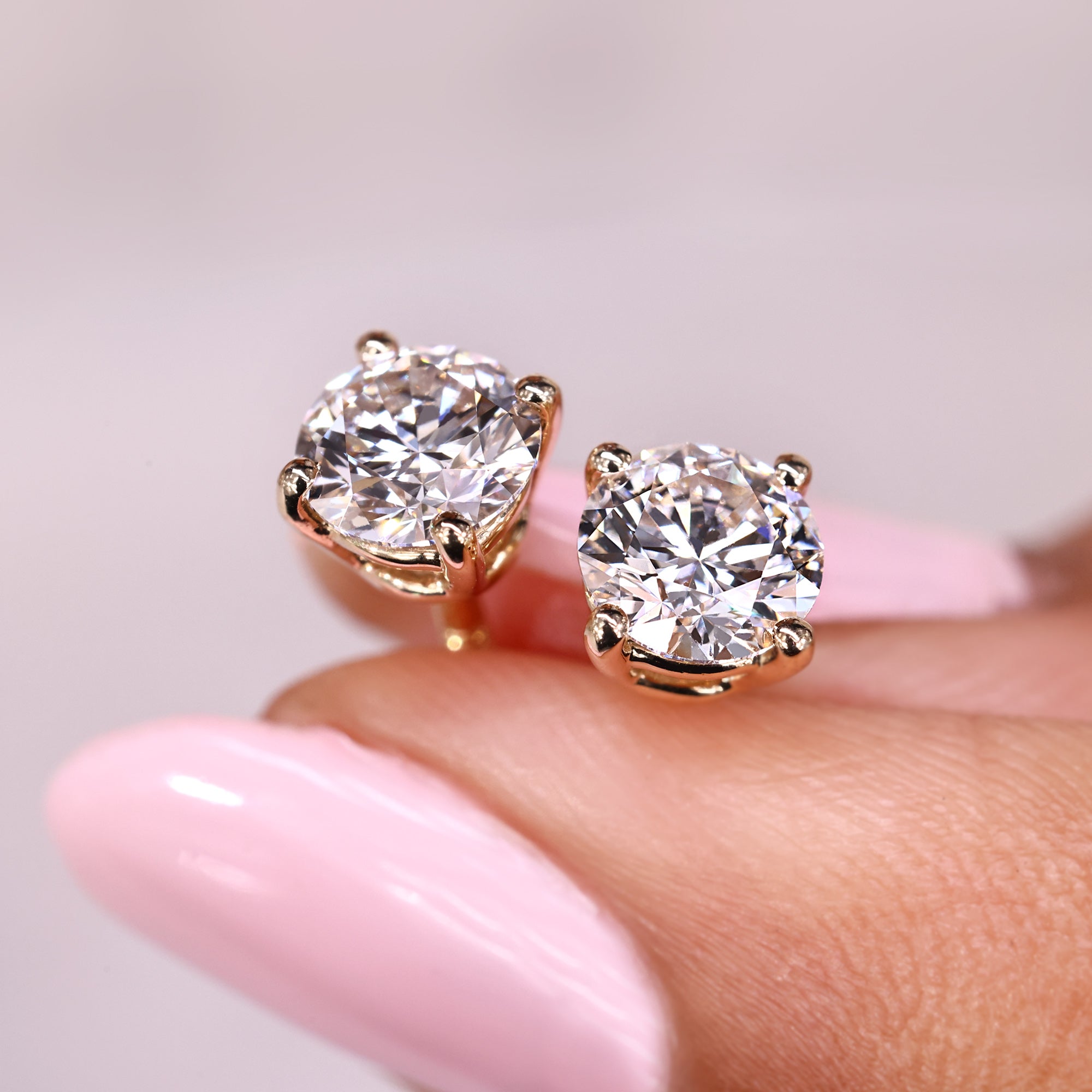Round diamond stud earrings made with lab grown stones.