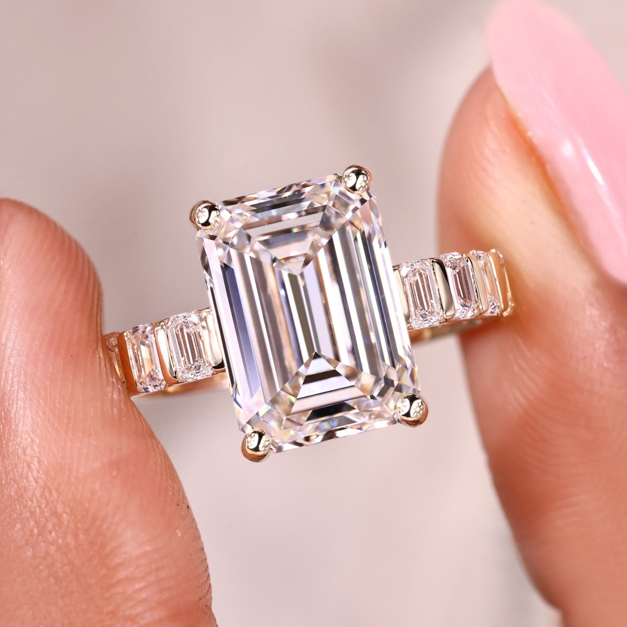 Emerald cut diamond ring with bar setting pave band.

