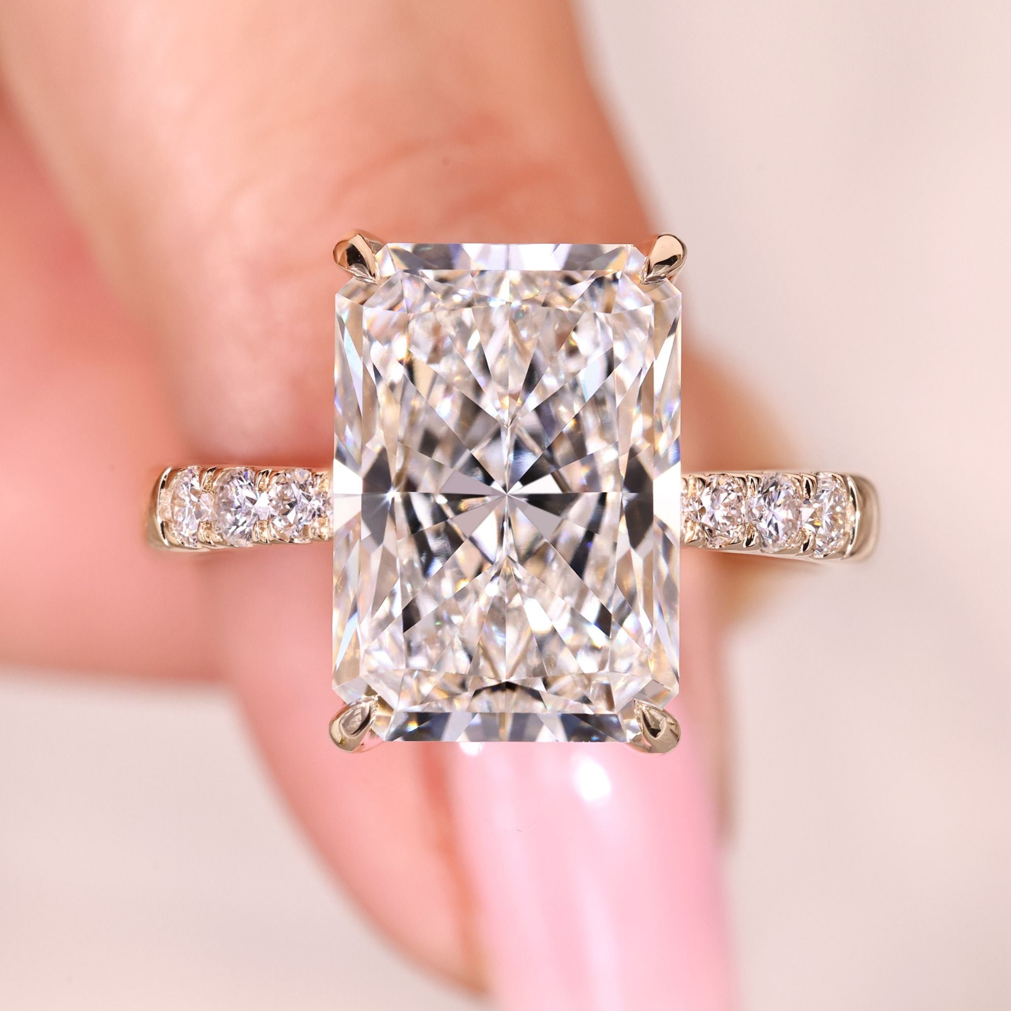 Hidden halo engagement ring with radiant cut center diamond.
