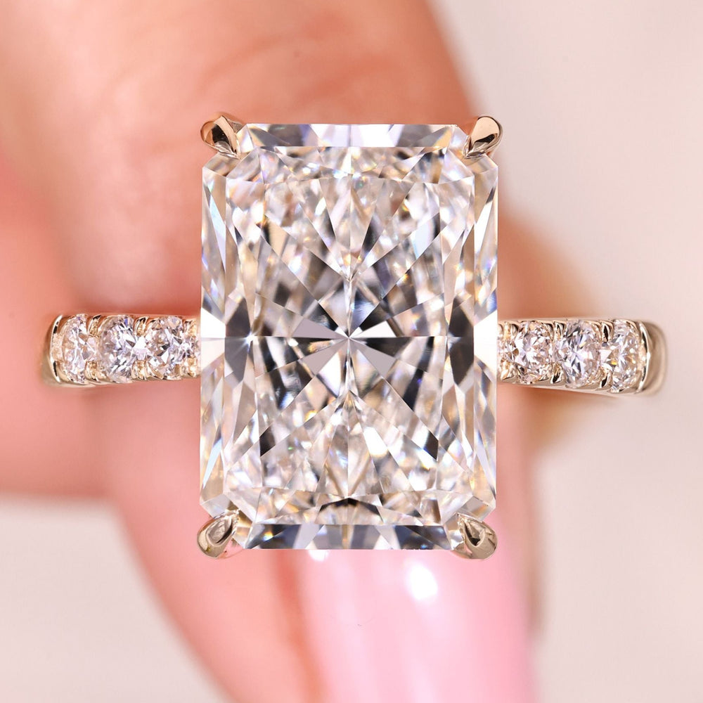 Hidden halo engagement ring with radiant cut center diamond.
