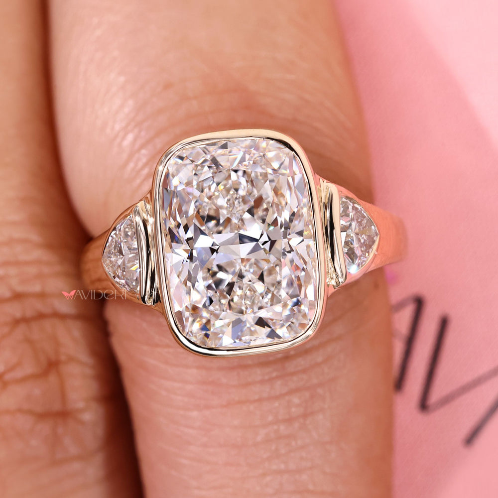 Handmade cushion cut ring with bezel and cathedral style.