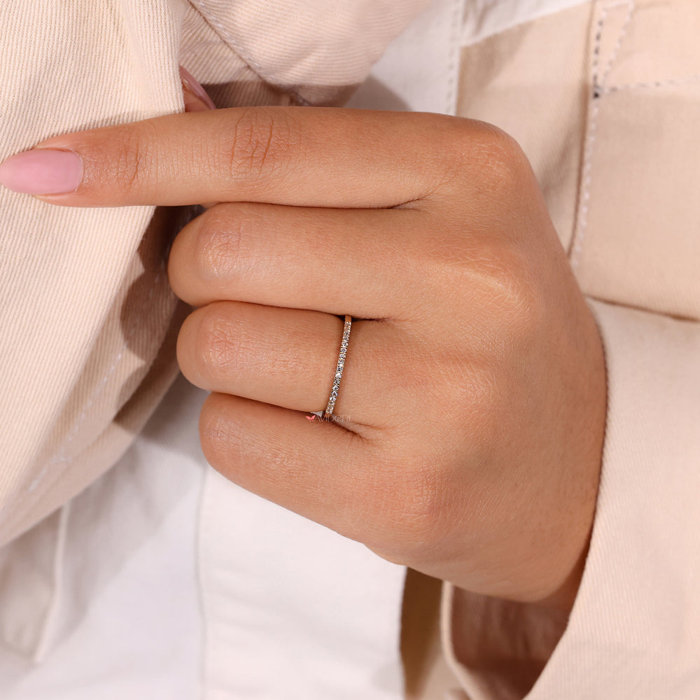 A handmade low setting wedding band in yellow gold with a half eternity diamond design.
