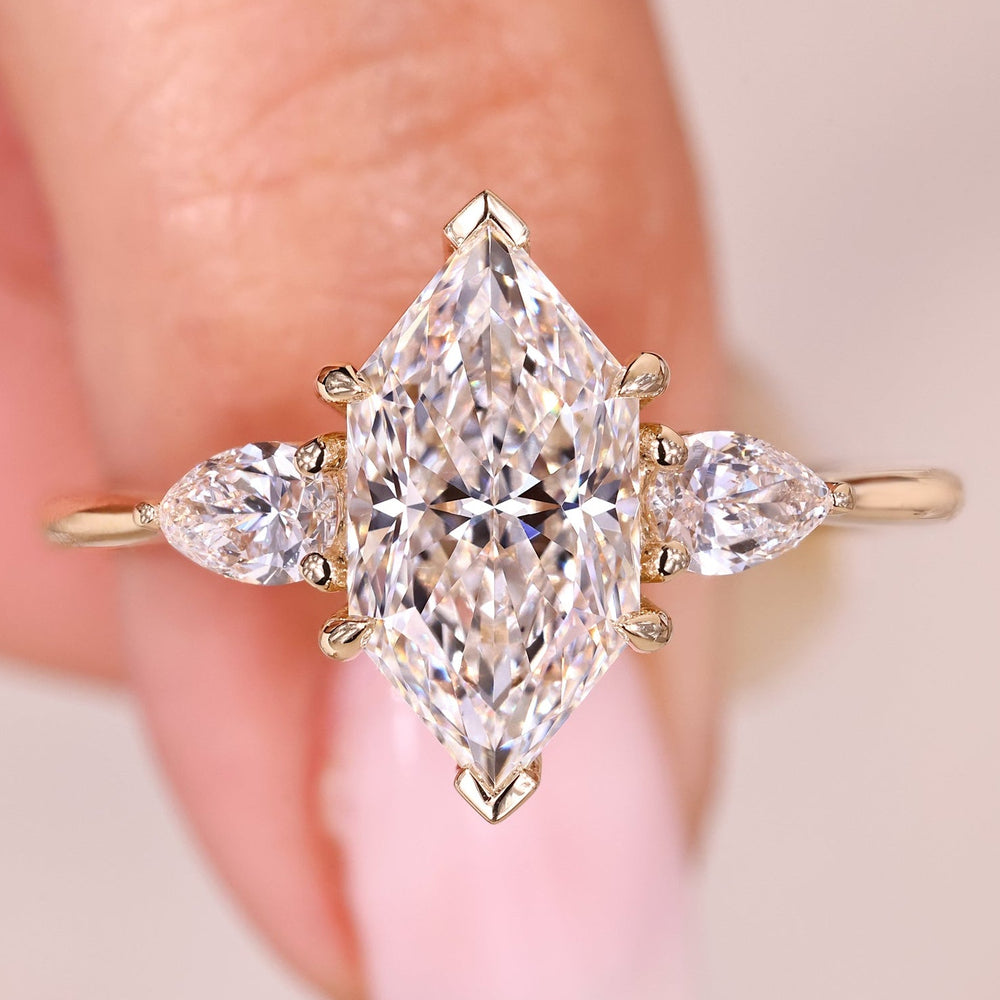Dutch marquise diamond ring with pear side stones.
