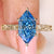 Dutch marquise blue diamond engagement ring with floral details
