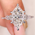 Dutch marquise engagement ring with kite and round side stones
