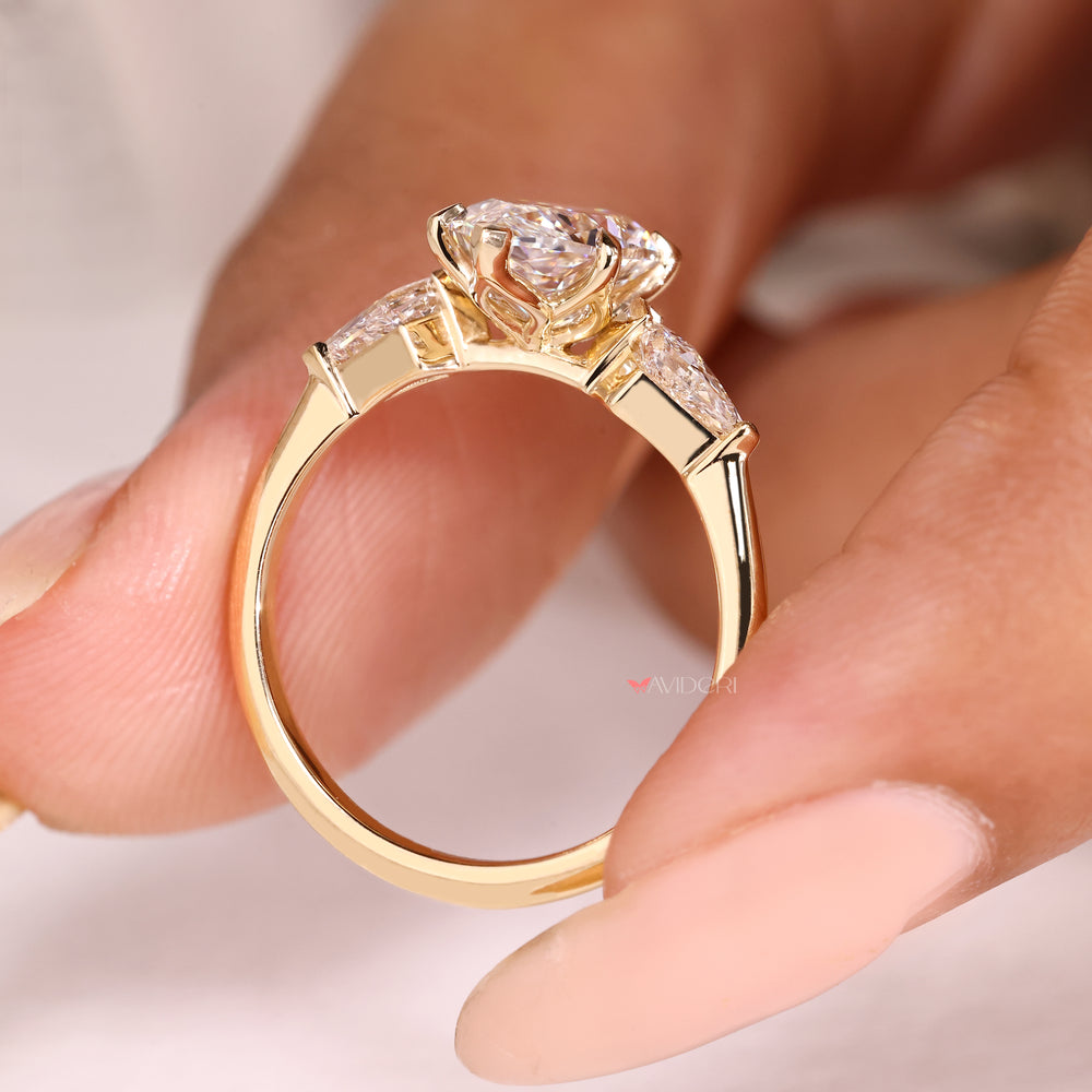 Three stone marquise ring with tulip style basket setting

