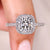 Cushion cut diamond ring with halo and pave style.

