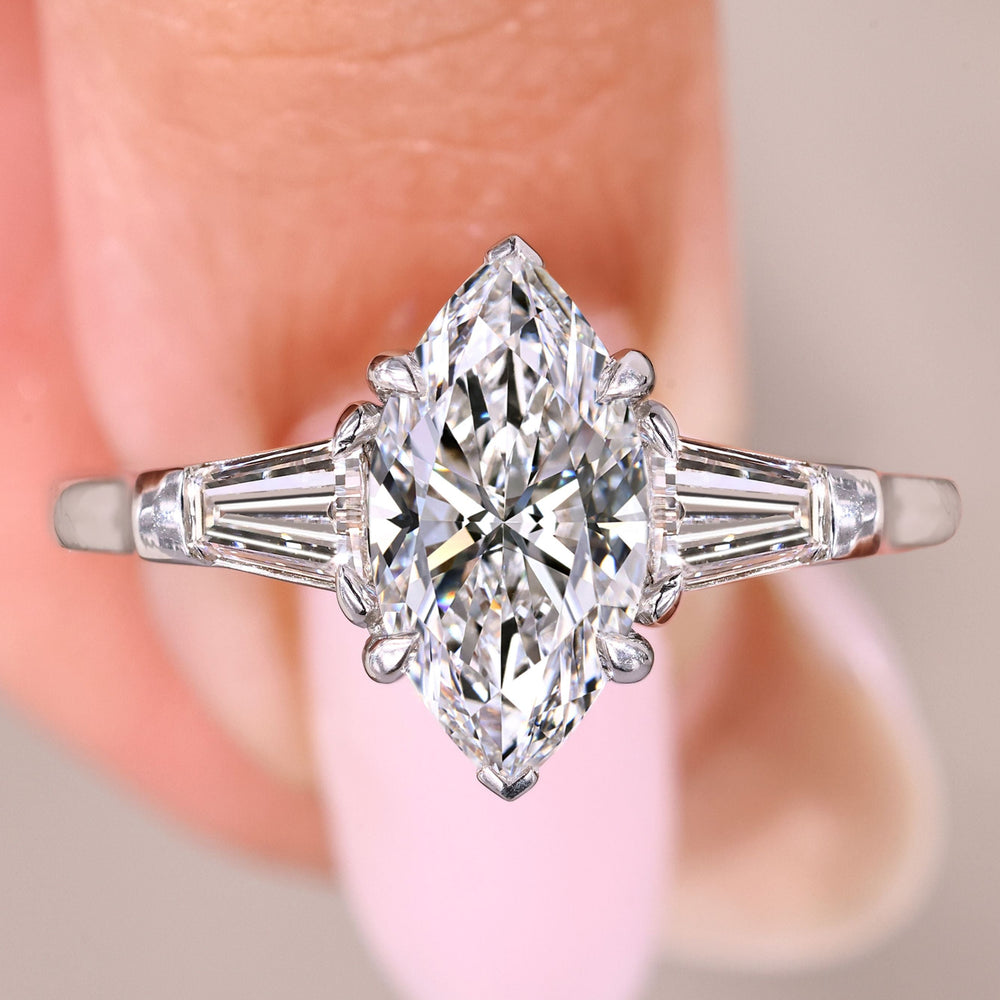 Marquise cut diamond ring with baguette sides.