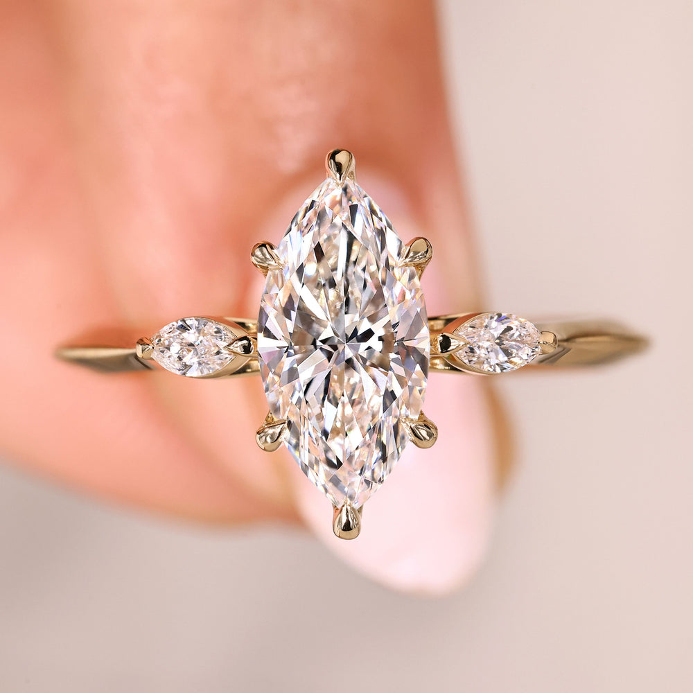 Marquise cut diamond ring three stone tulip.
