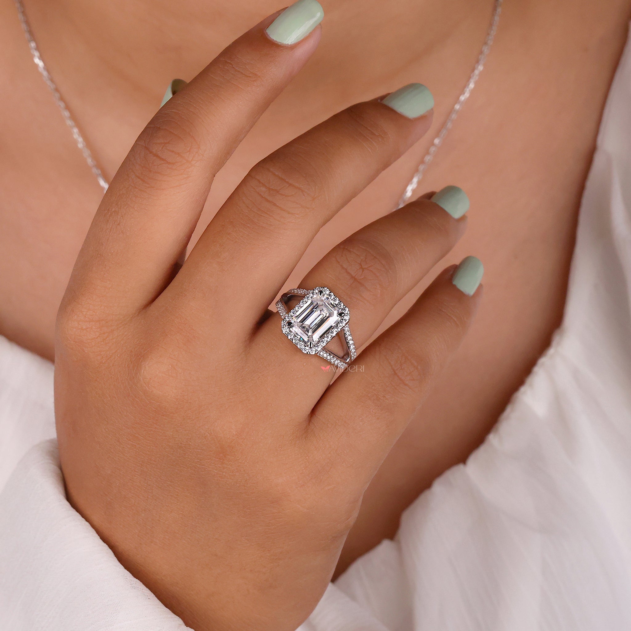 Emerald Moissanite engagement ring with a distinctive stone in a classic setting.
