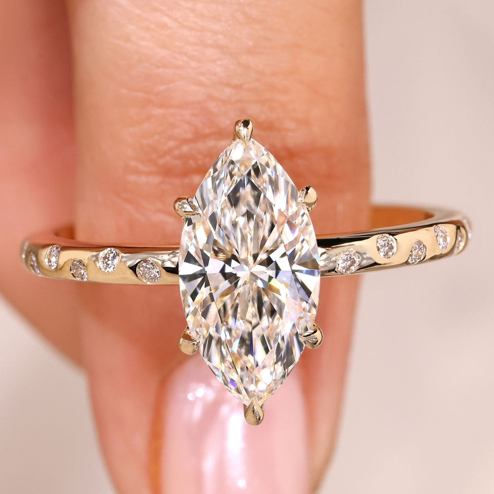 Marquise diamond ring flush pave with round stones.
