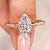 Marquise diamond ring flush pave with round stones.

