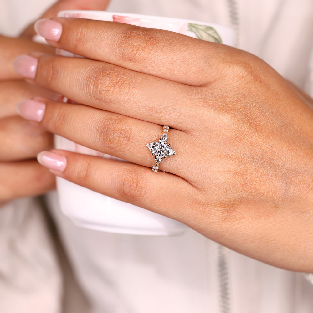 Marquise ring shared prong pave with side stones.
