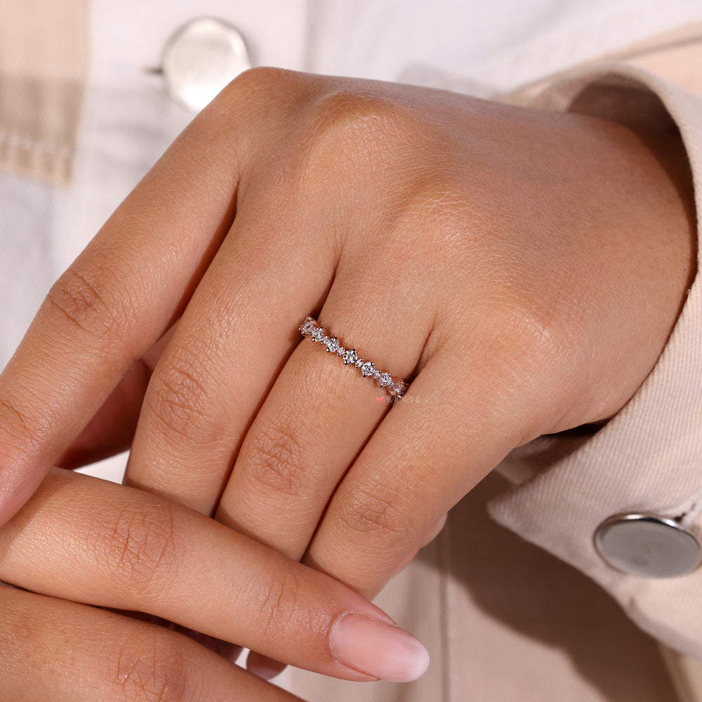 Round cut wedding band featuring brilliant diamonds.
