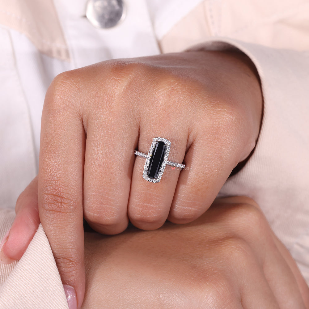 Elongated cushion cut engagement ring in a halo setting with moissanite accents.

