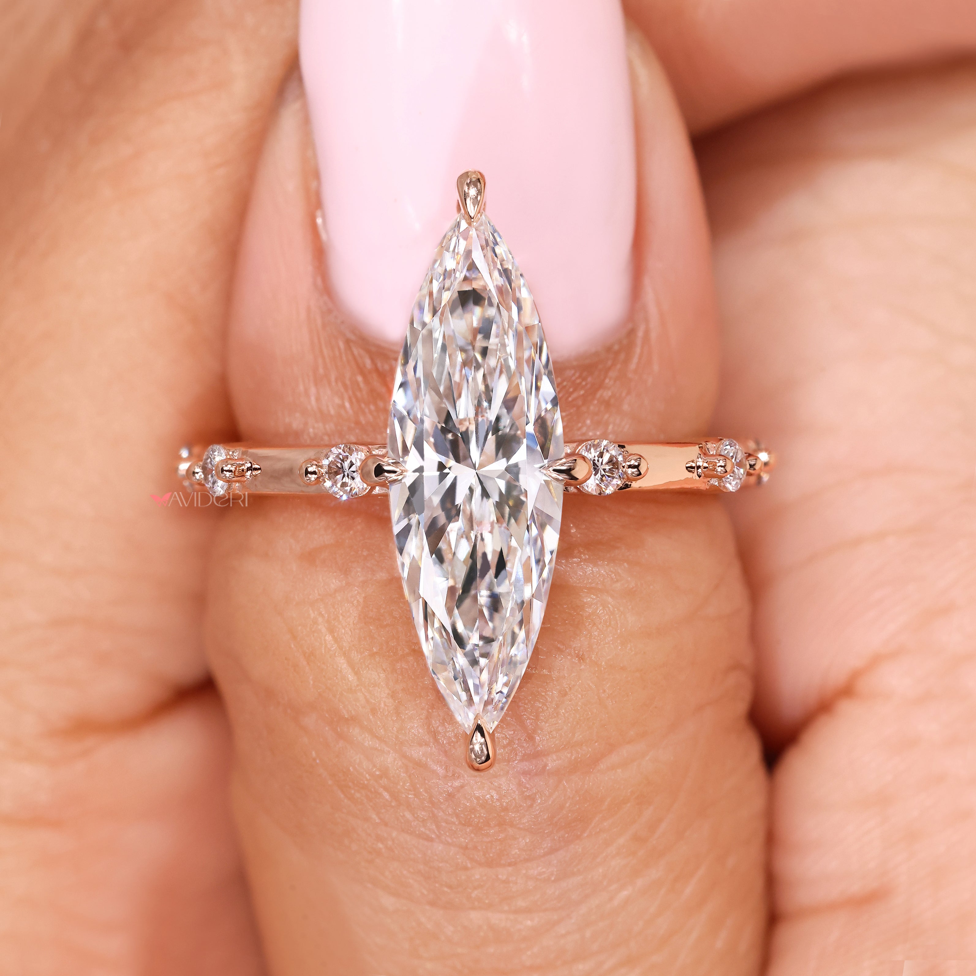 Marquise diamond ring with basket setting and pave accents
