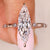 Elongated marquise engagement ring with distant pave diamond accents
