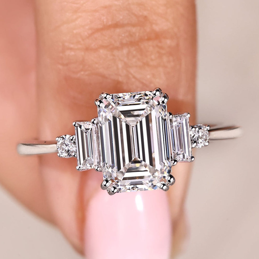 Five stone diamond ring with emerald cut center stone.

