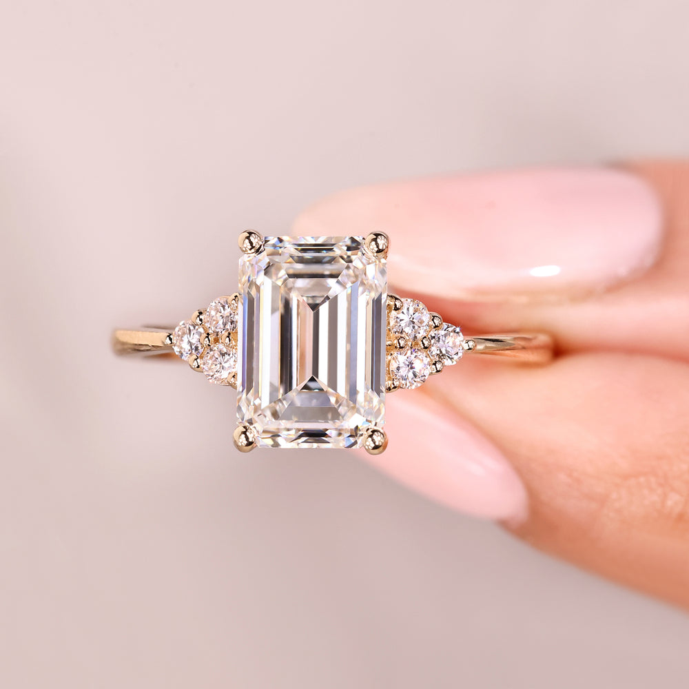 Emerald cut diamond ring with round accents.
