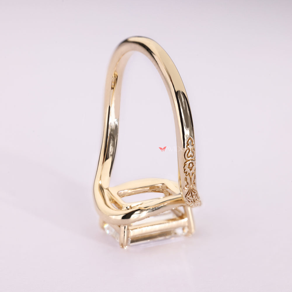 Solitaire emerald cut ring with bypass design.
