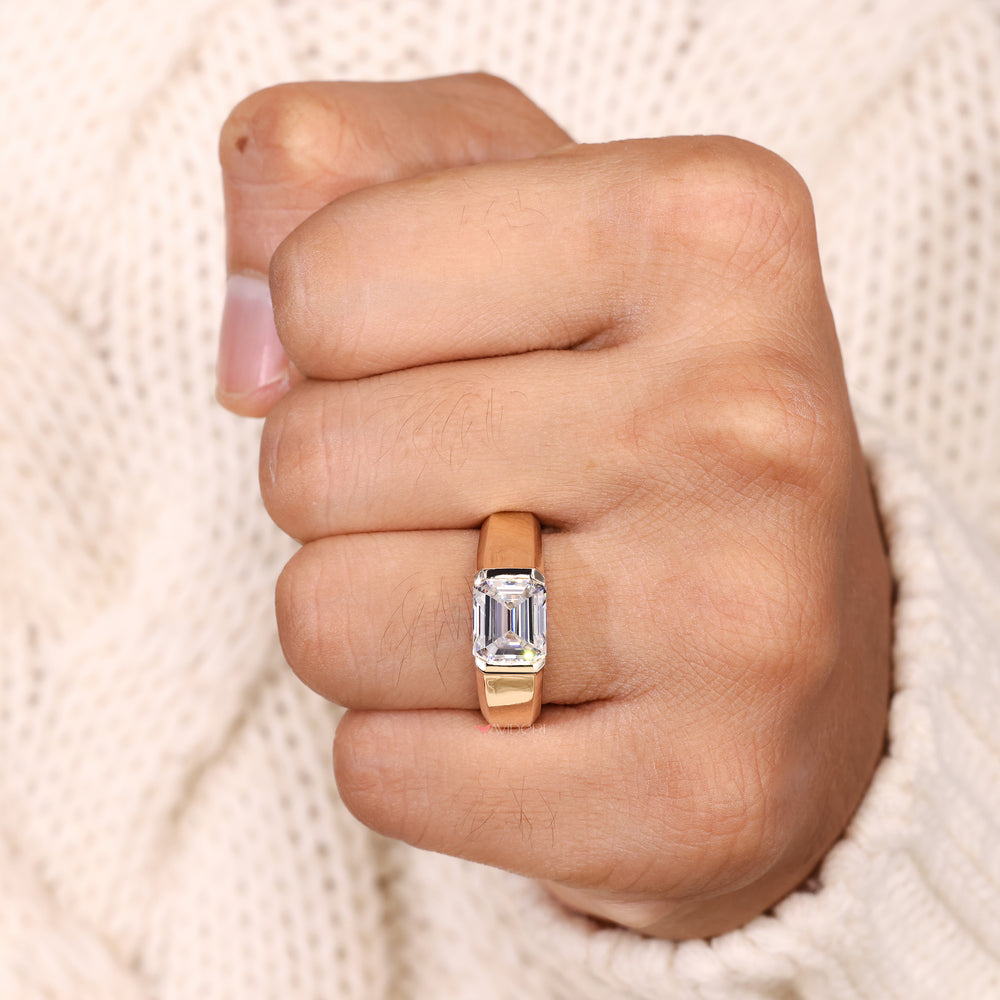 Solitaire emerald cut ring bezel set style.
