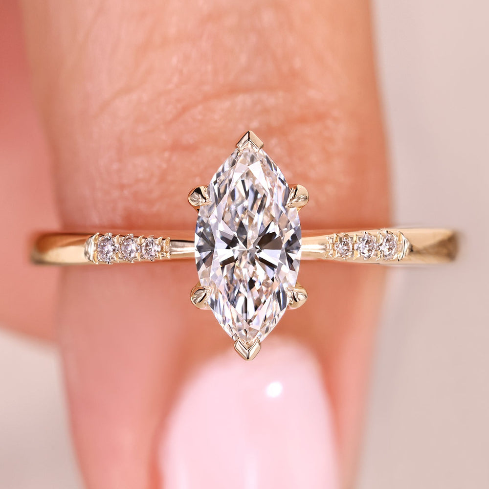 Marquise diamond ring with elegant tapered shank design.
