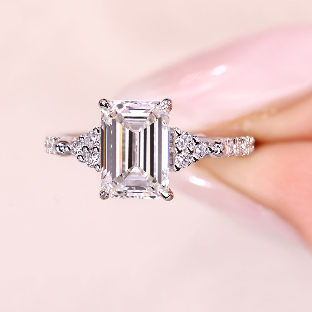Elegant emerald diamond ring with pave style band.
