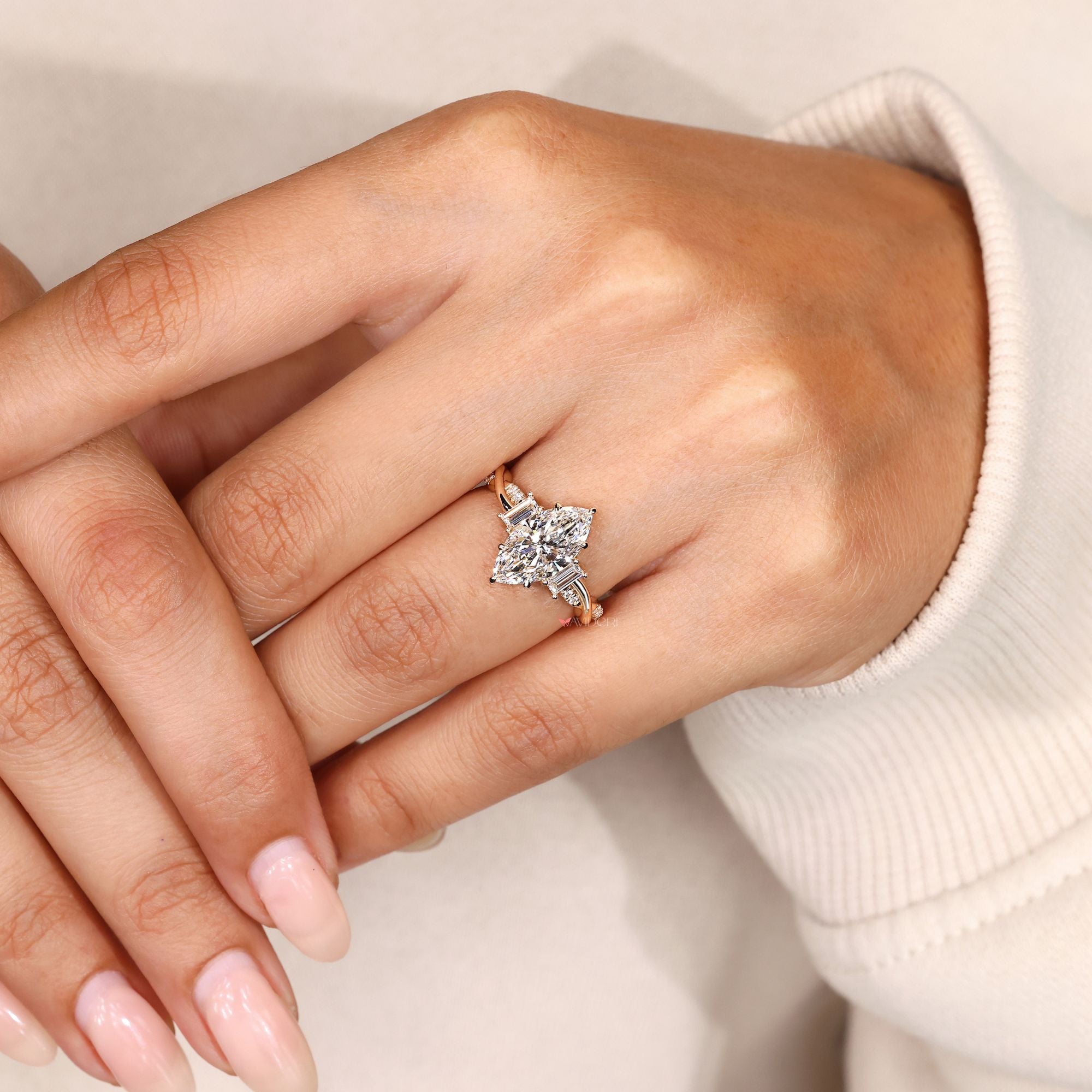 Lab grown marquise diamond ring with side stones.
