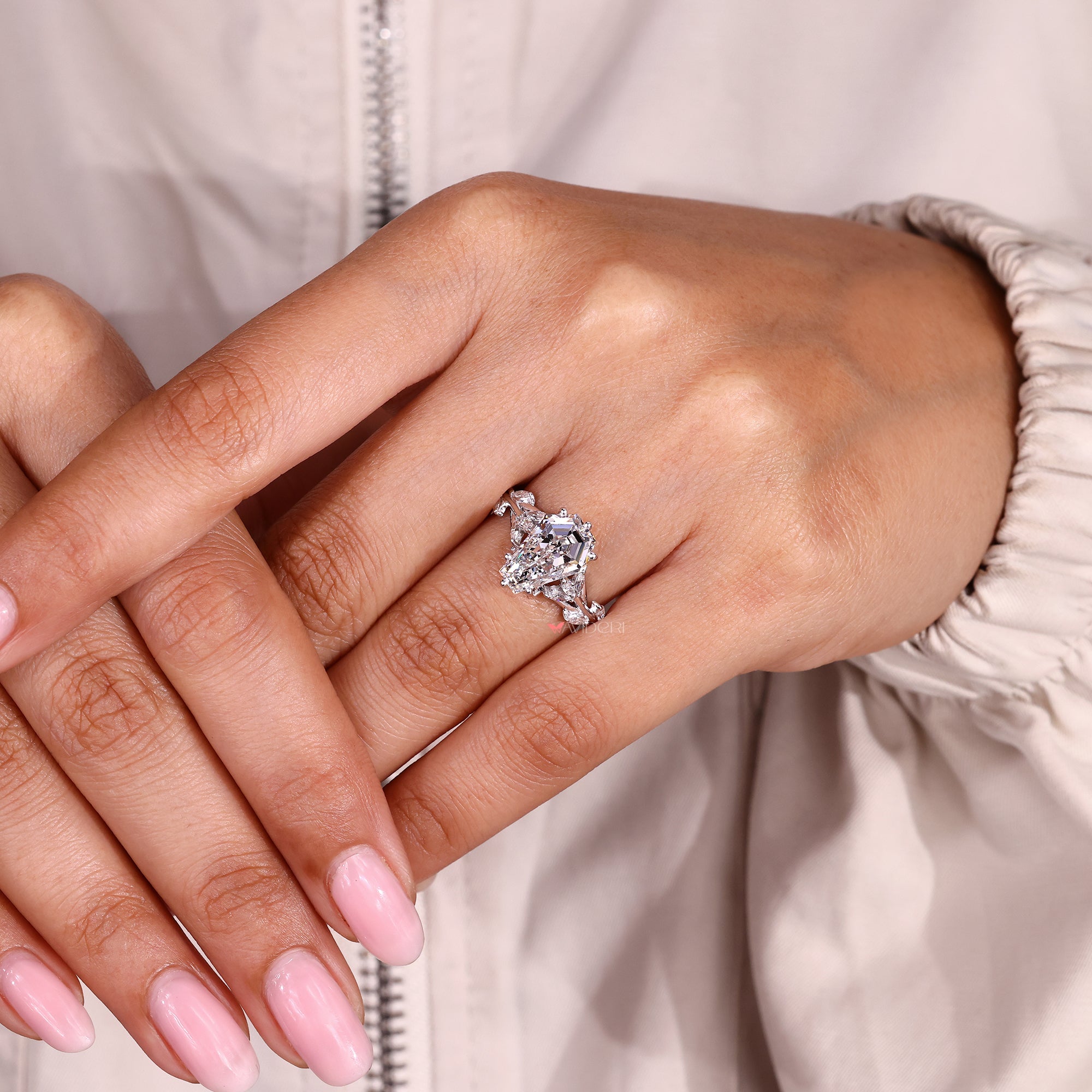 Coffin cut diamond engagement ring with elegant cluster style.
