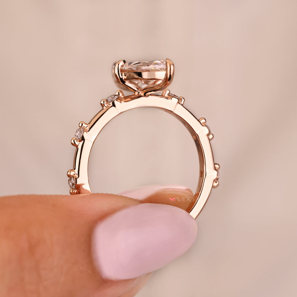Elongated marquise ring with round diamond pave style details
