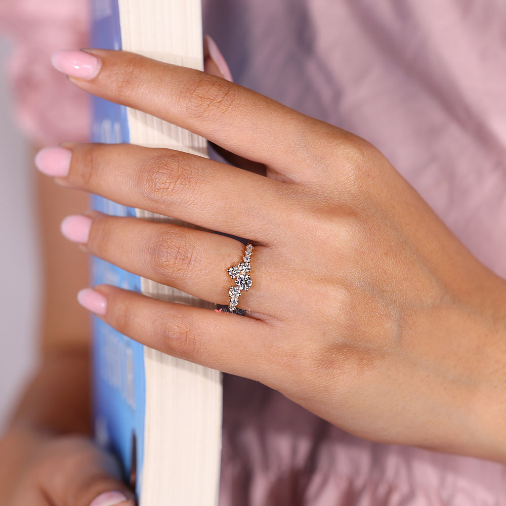 Round diamond ring with prong set cluster design.