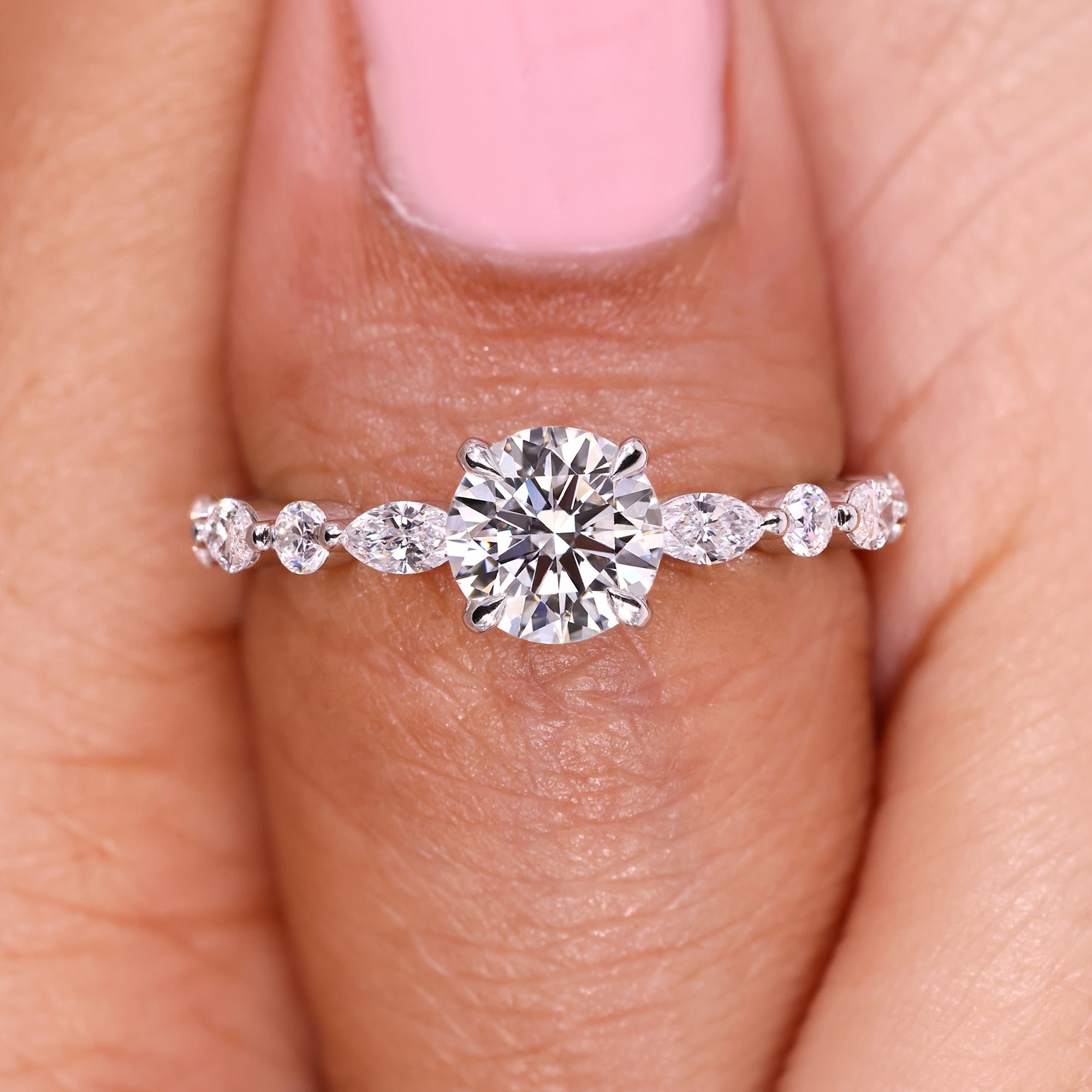 Round diamond ring with modern bubble prong setting.