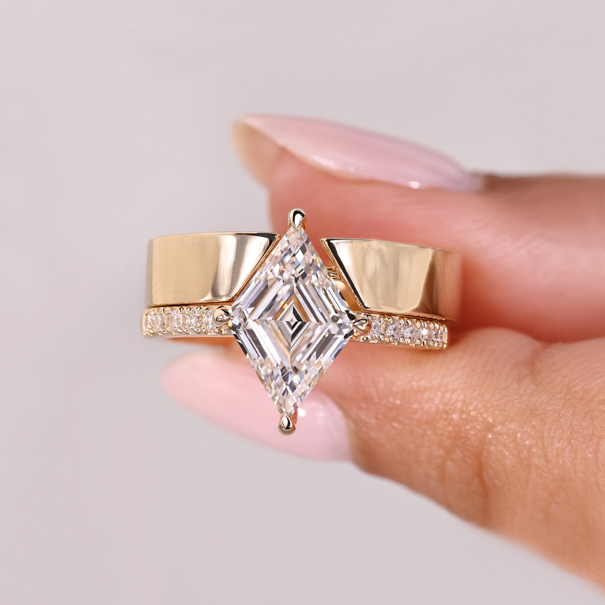 Cathedral lozenge diamond ring with wedding band.
