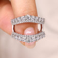 Enhancer wedding band with round cut moissanite.
