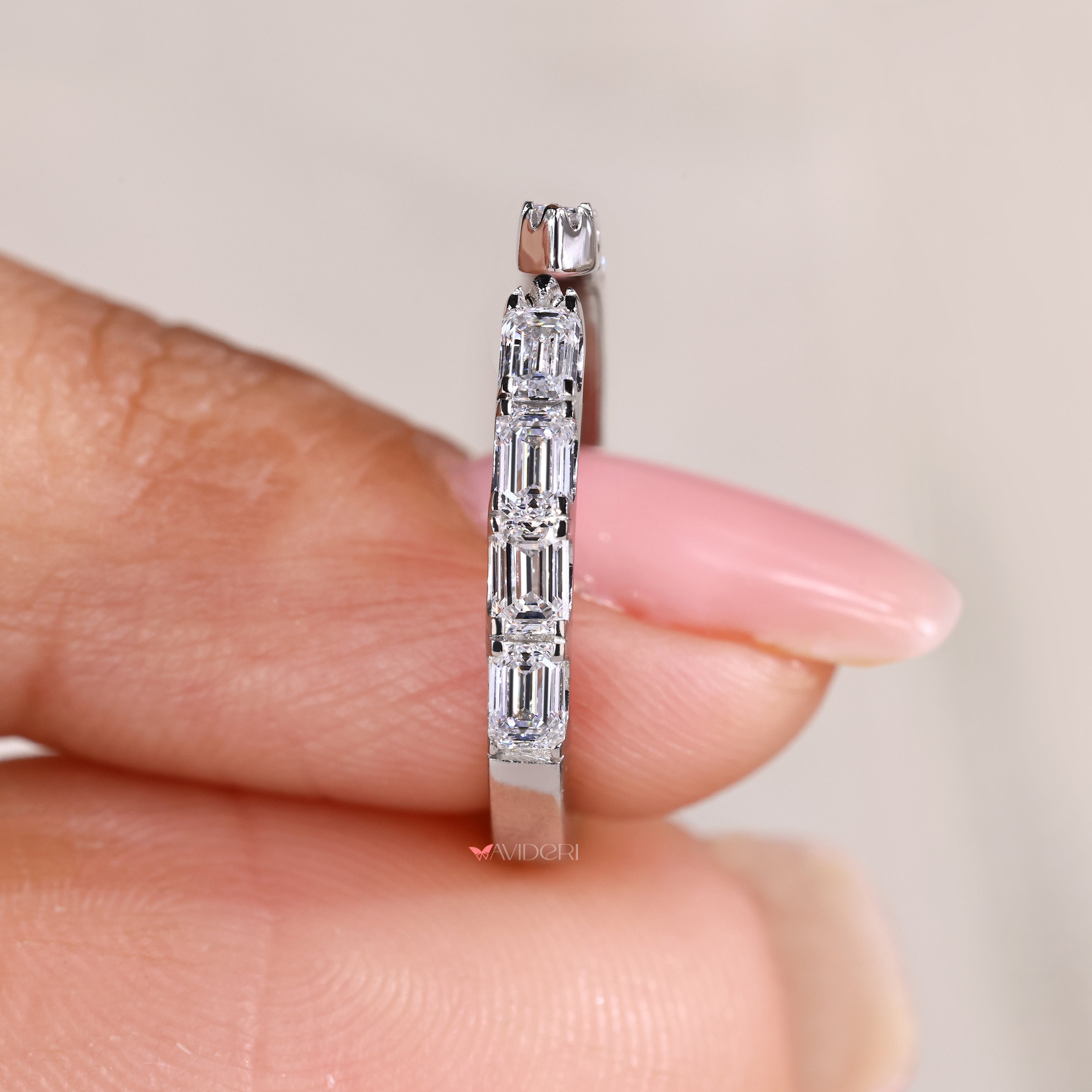 Open gap eternity band with emerald cut diamond stones

