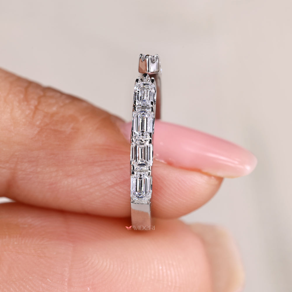 Open gap eternity band with emerald cut diamond stones
