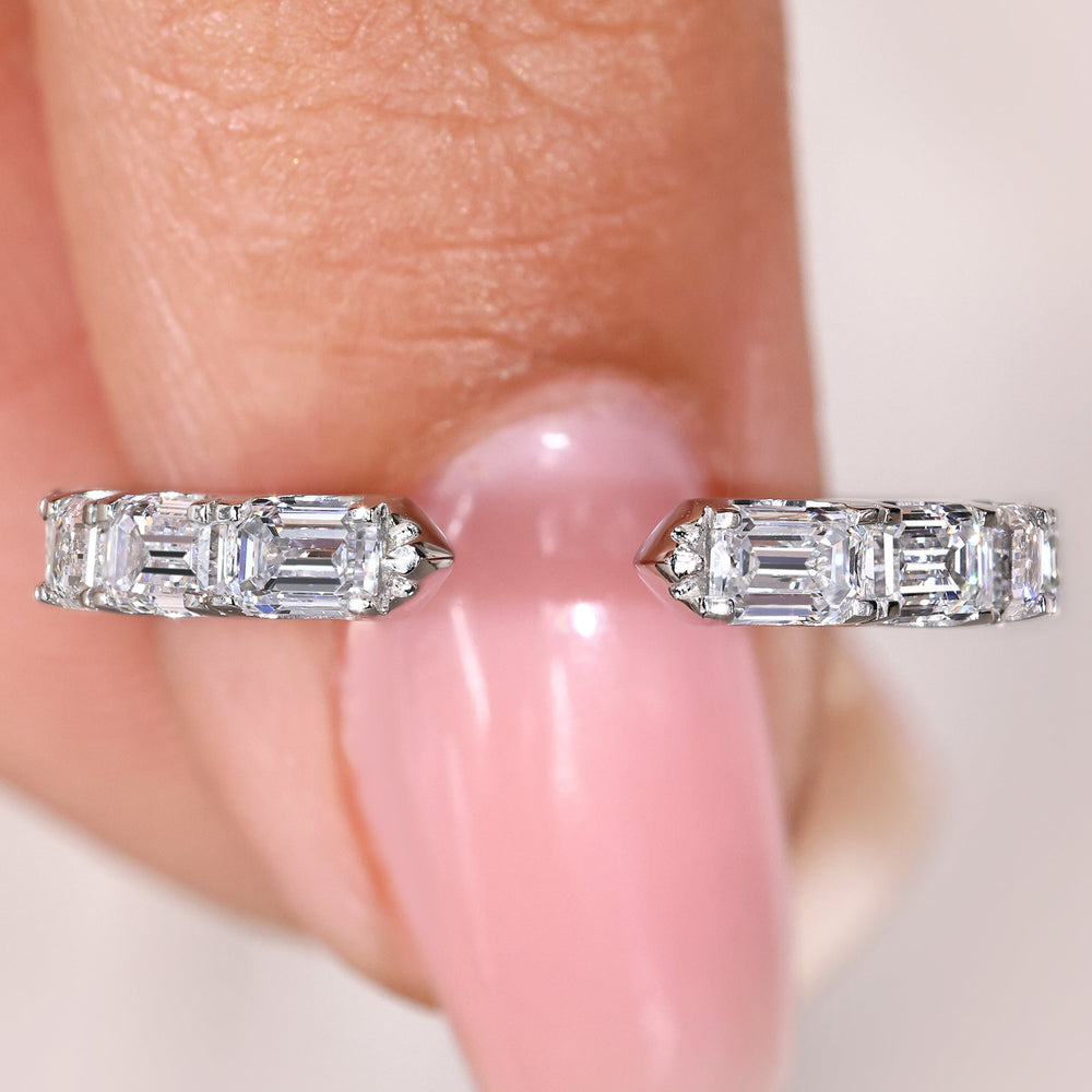 Emerald diamond eternity wedding band with open gap design
