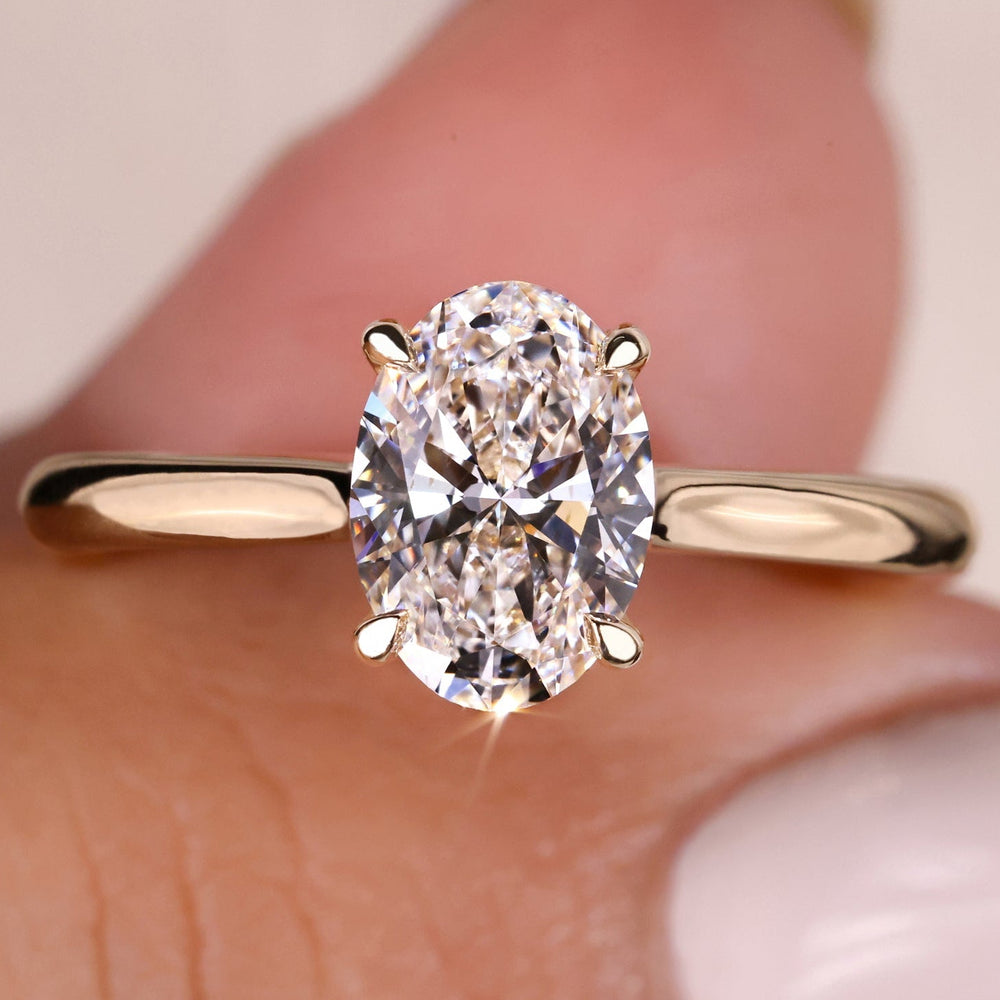 An Image of a hand wearing Solitaire oval engagement ring.