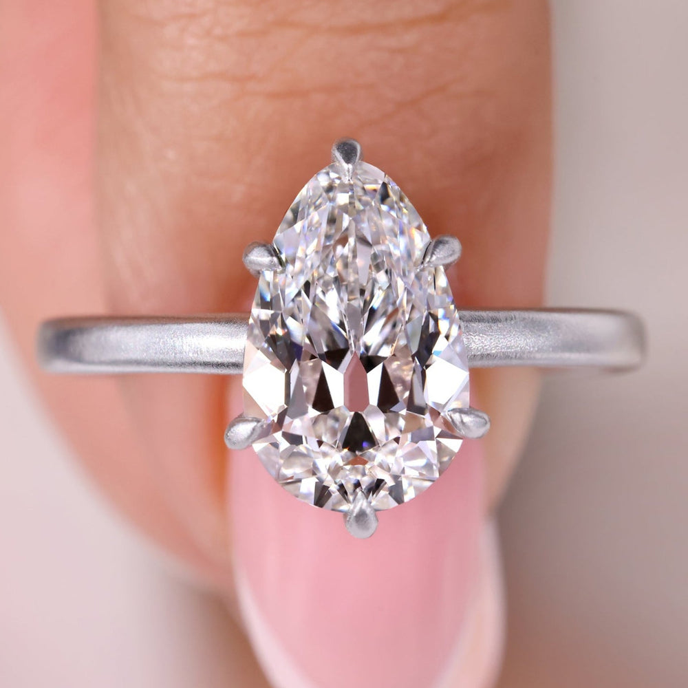 Pear shape engagement ring with a stunning old European cut diamond.
