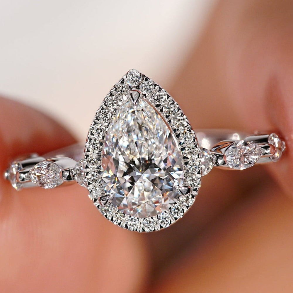 Pear engagement ring with delicate detailing.
