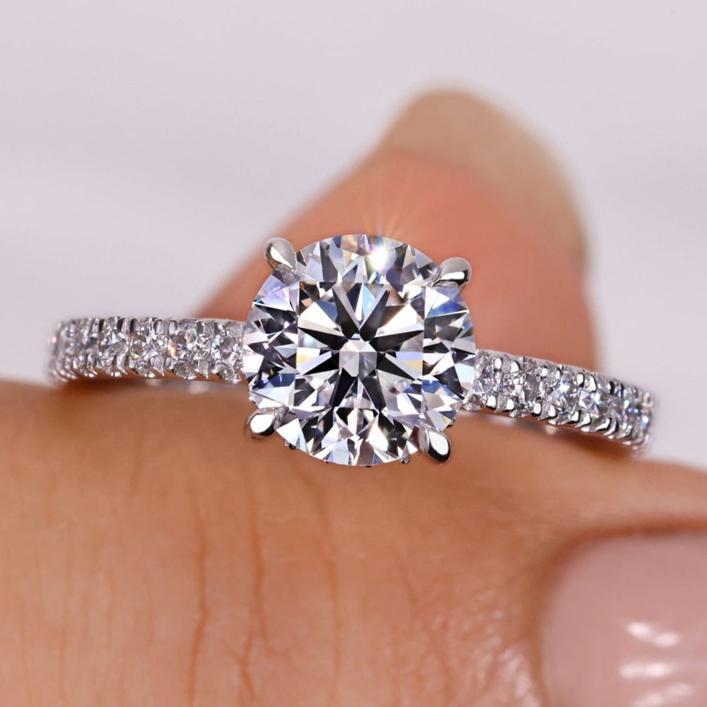 Hidden halo engagement ring with a stunning round diamond, offering timeless elegance for engagements and special occasions.

